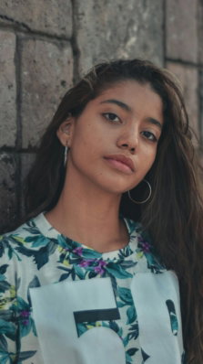 woman in white blue and green floral shirt